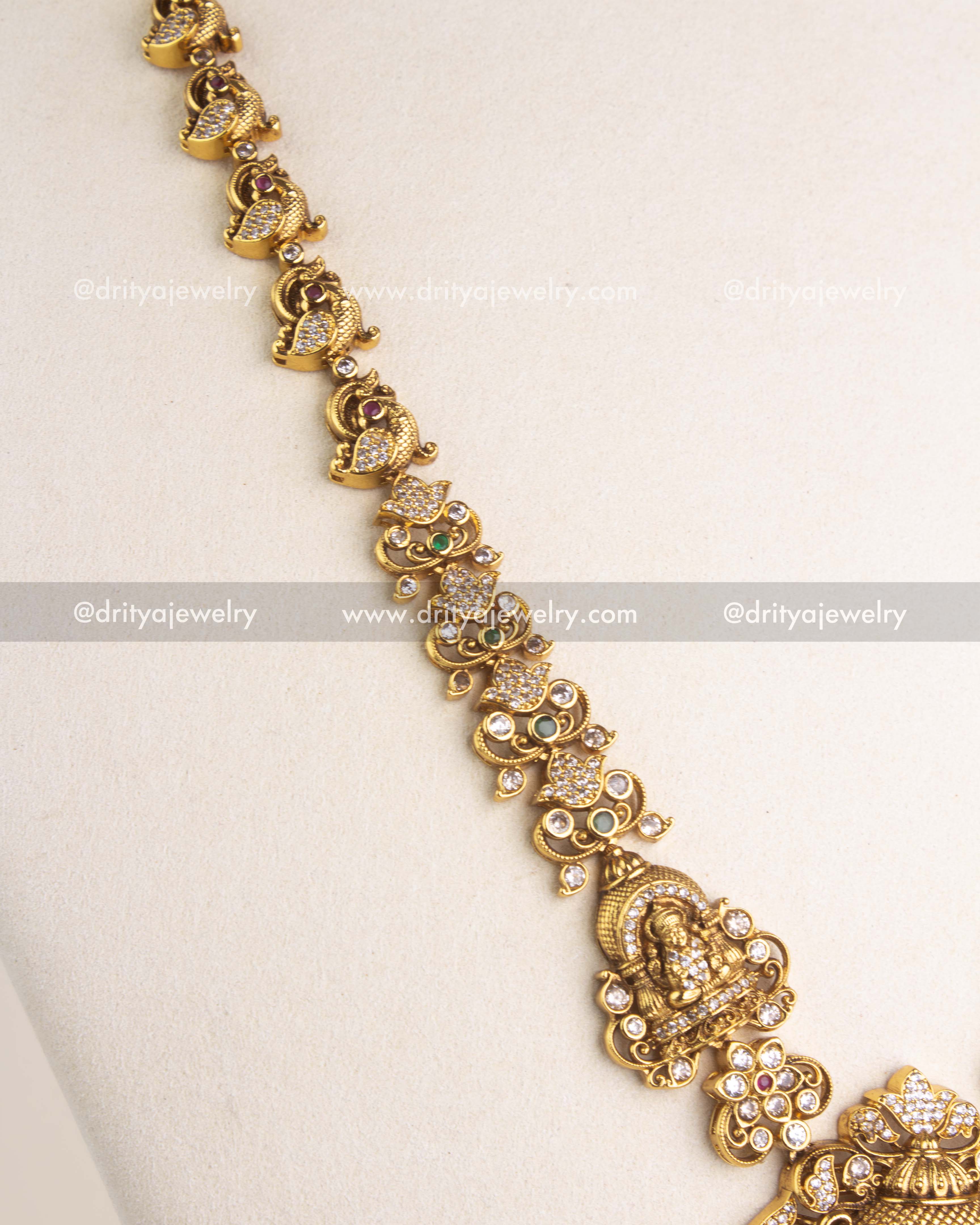 SKU 1169 detailed side view of sculpted deity and paisley links along the long necklace chain