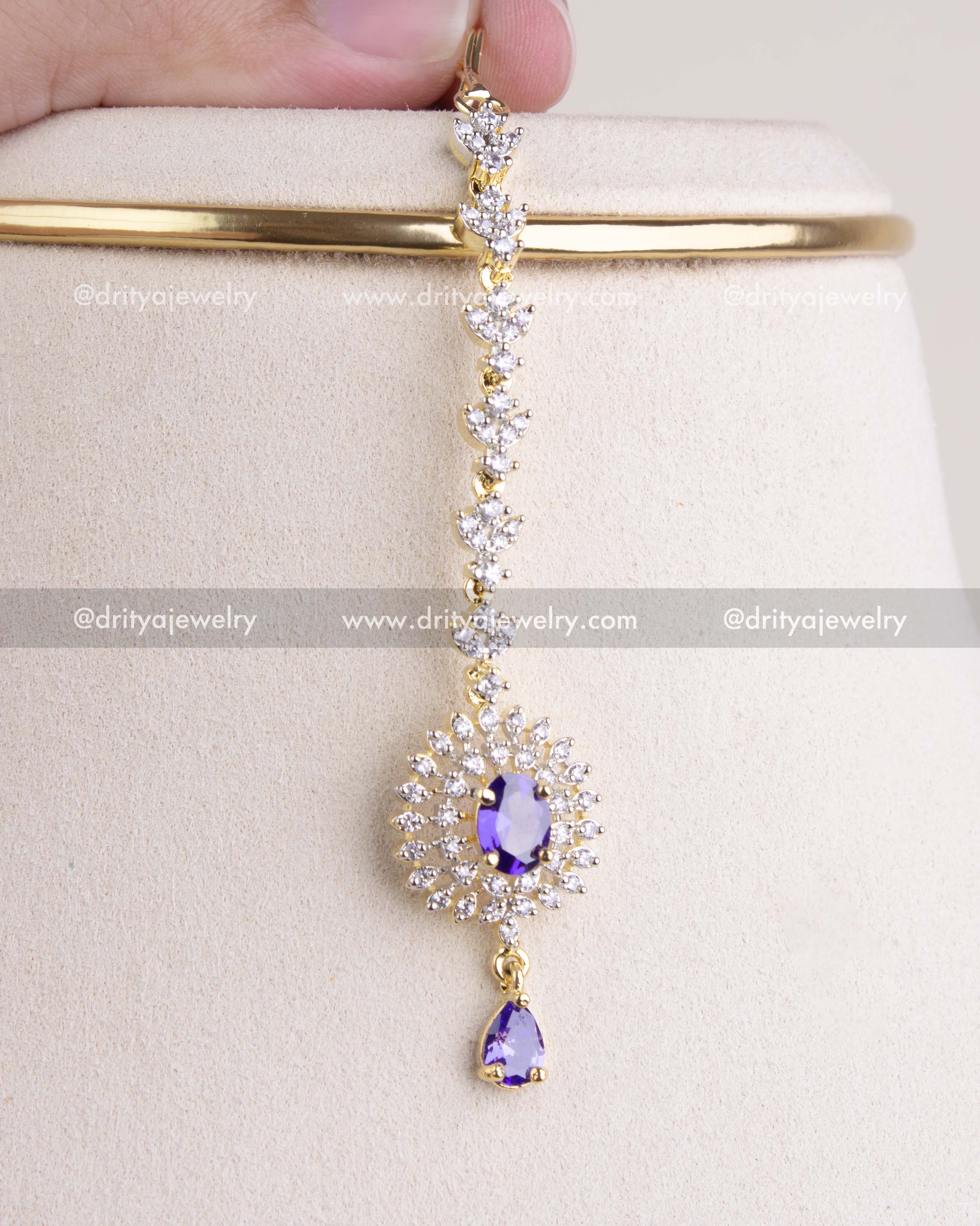 1210-PU maang tikka with purple stone and CZ halo detailing front view
