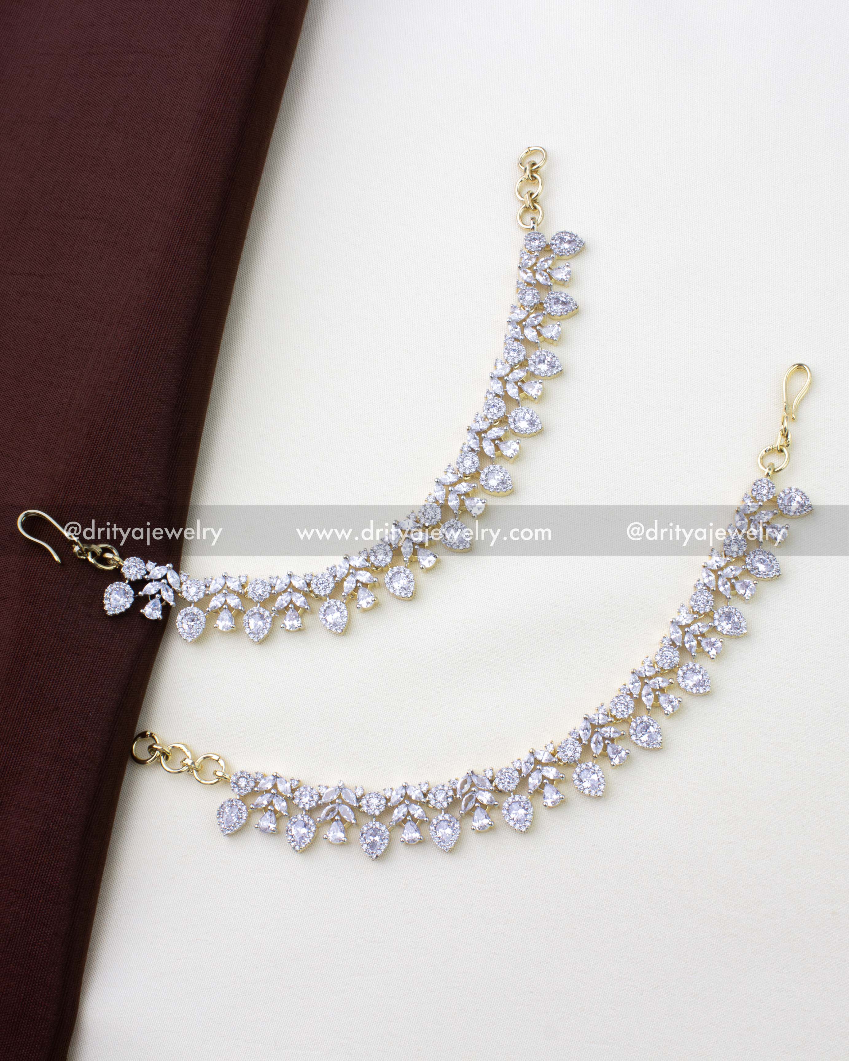 1273-G pair of floral stone-studded anklets laid flat full view