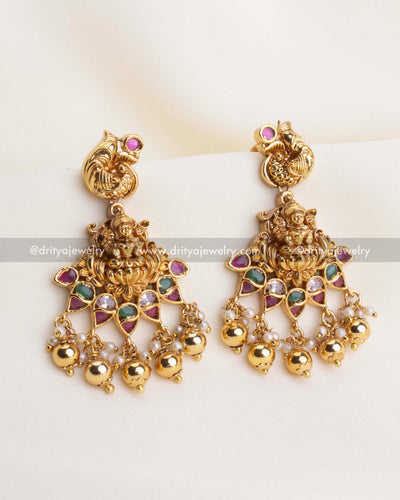 SKU 1105 Necklace Set - Close-up front view of temple-style god idol earrings with coloured stones and ghungroo drops