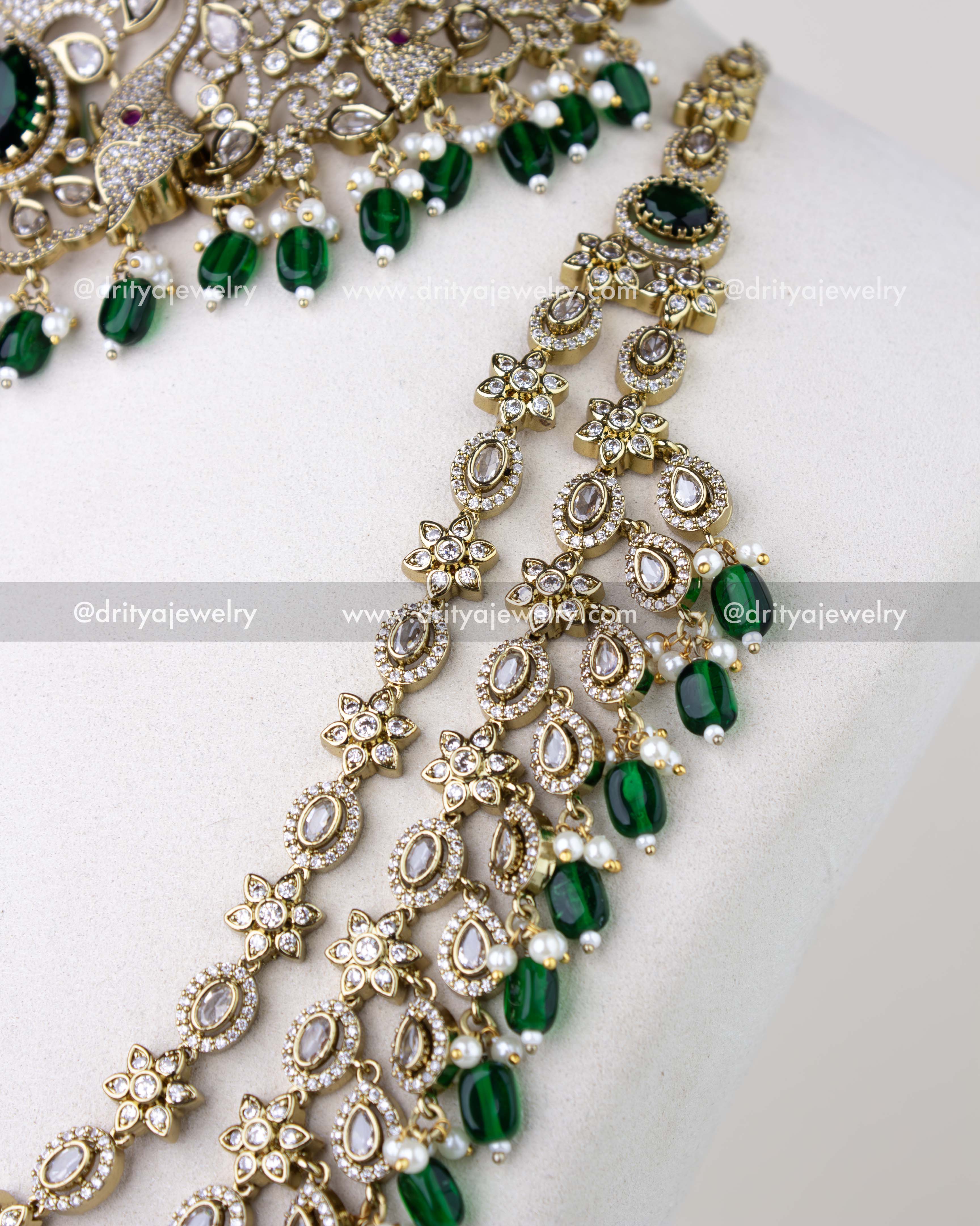 1309-GSET side view of long necklace strands with floral and teardrop motifs