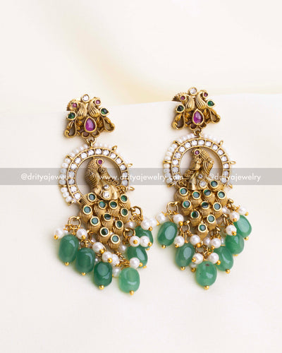 SKU 1108 Necklace Set - Close-up front view of peacock idol earrings with green bead and pearl drops