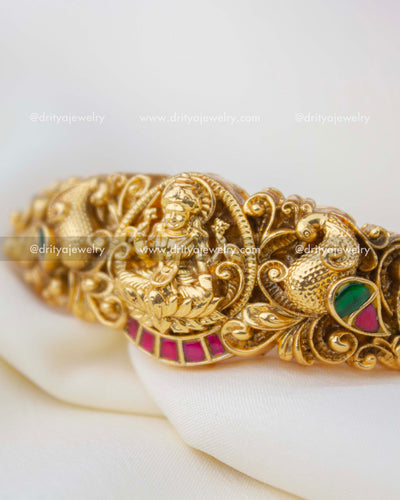 1298 - Close-up of god idol nakshi work with kemp stones on kada
