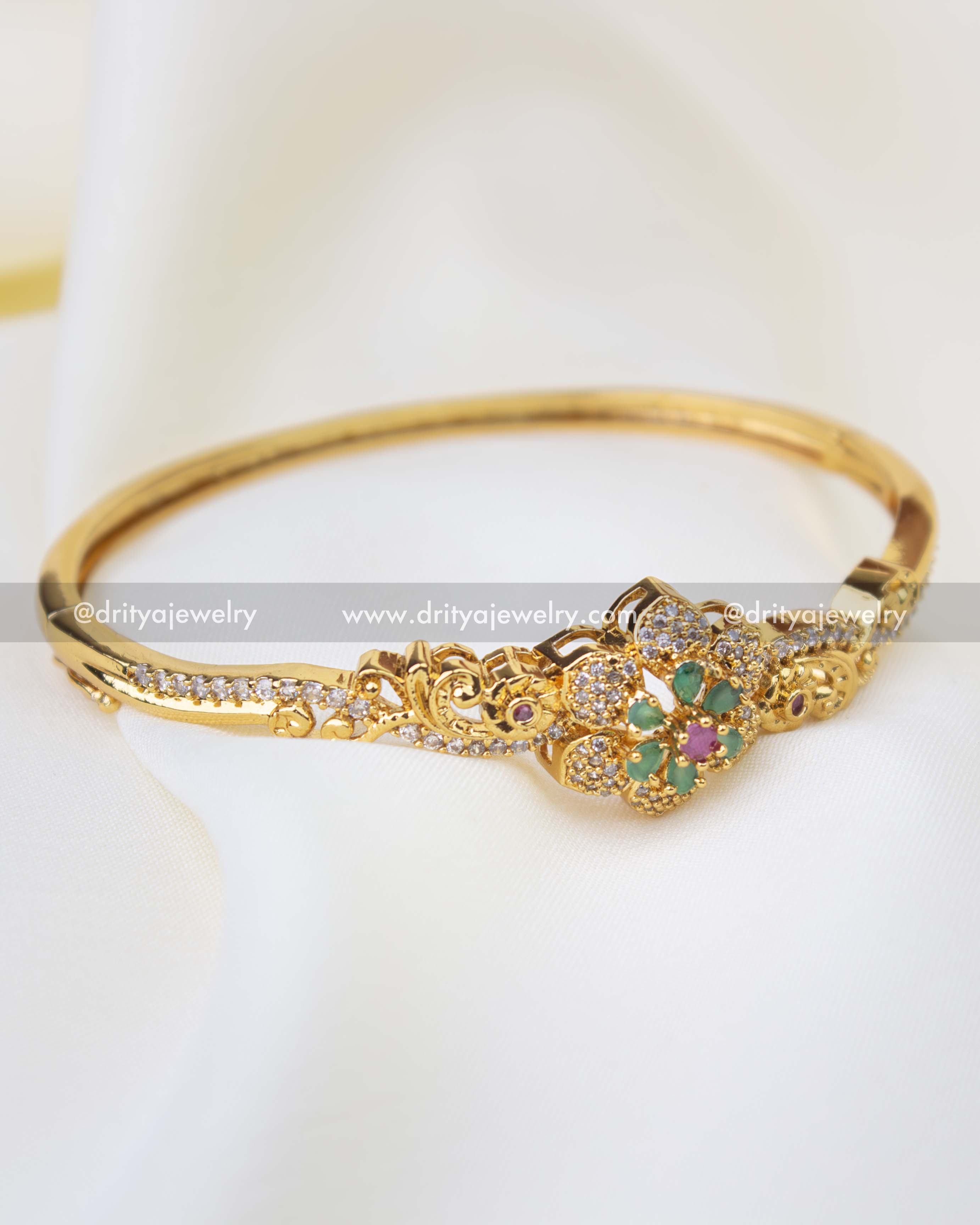 SKU 1256 gold-toned kada bangle with green and ruby floral centerpiece front view