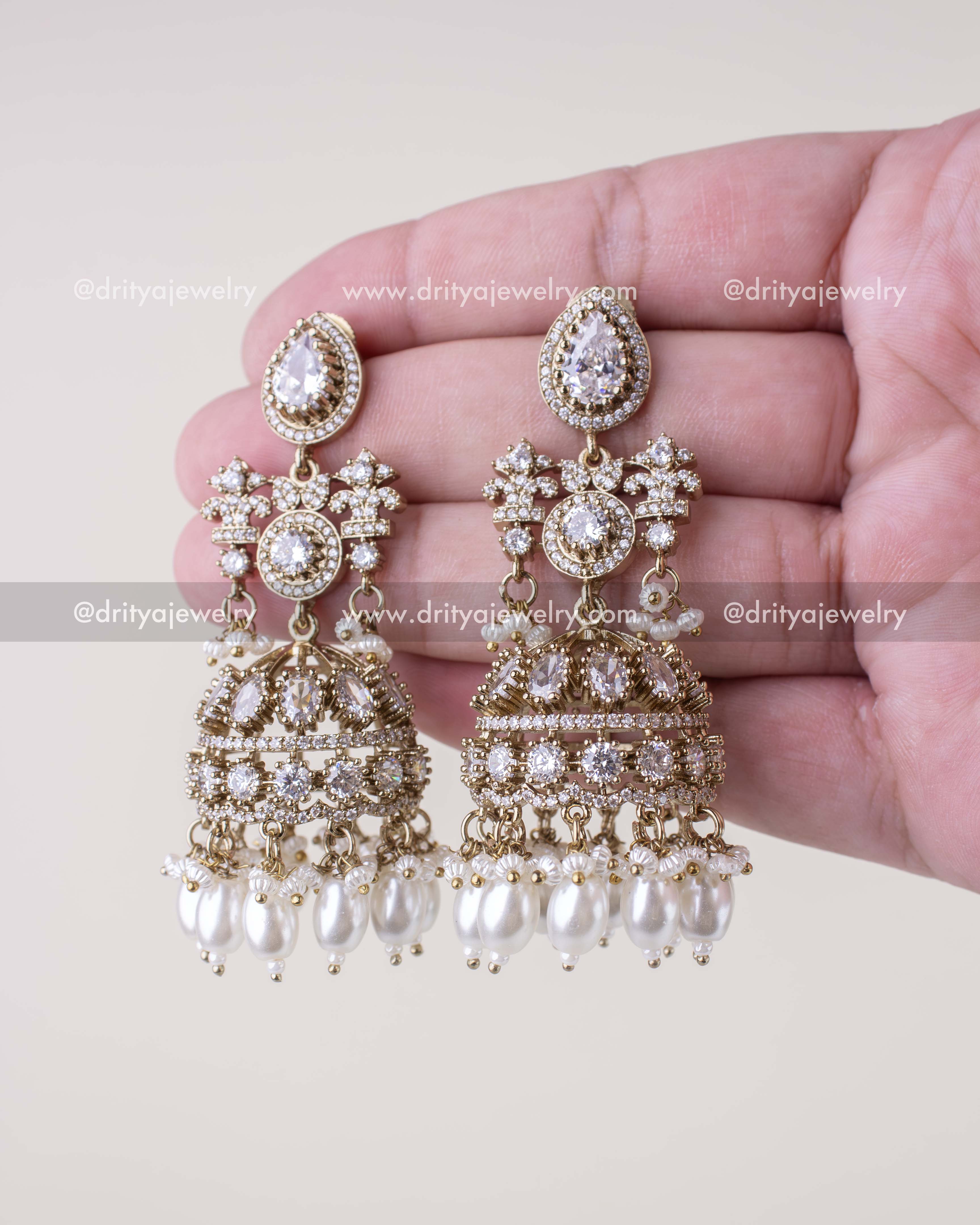 1257-W pair of premium Victorian bridal jhumka earrings front view in hand