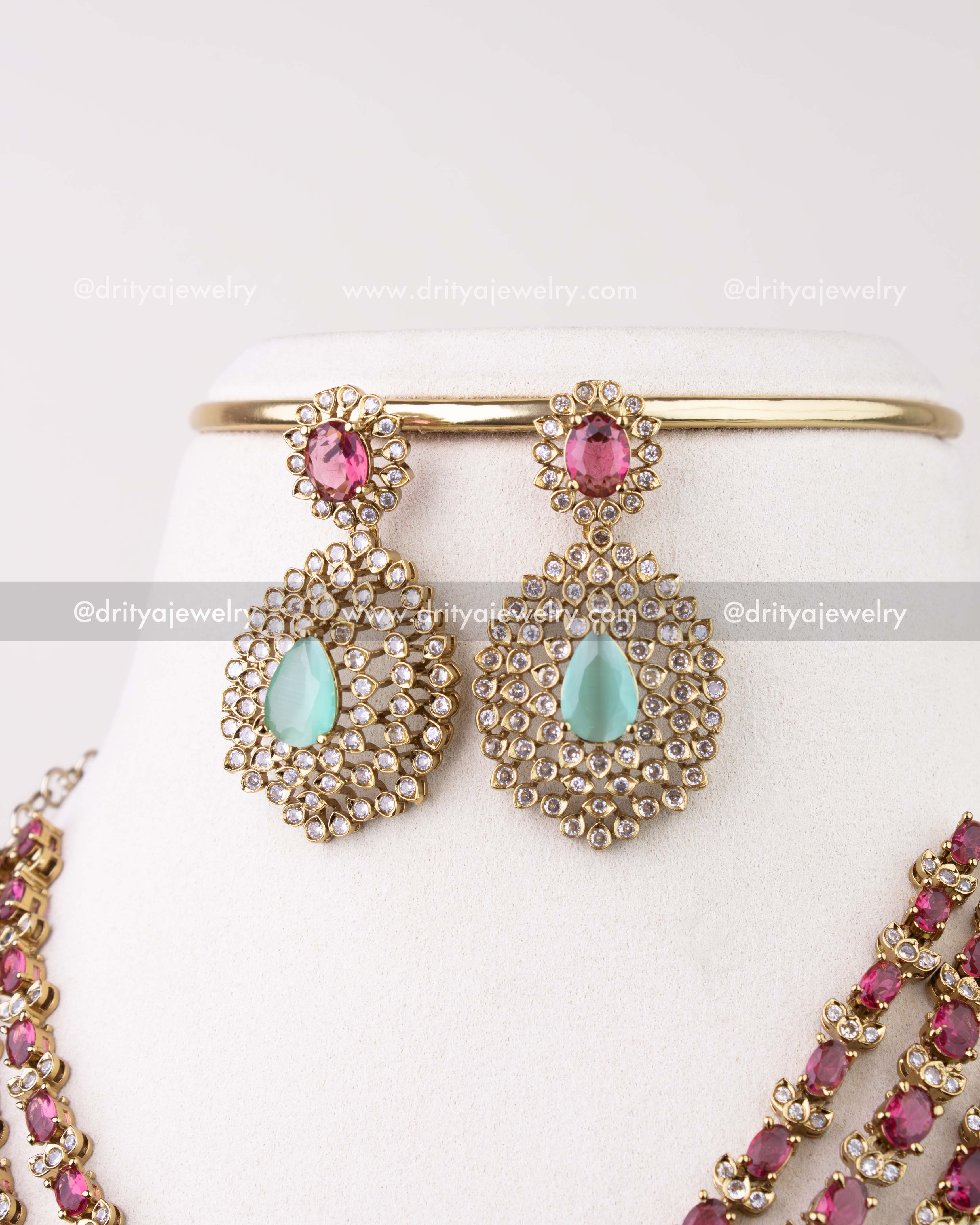 1296-R close-up of matching ruby and mint drop earrings with stone halo