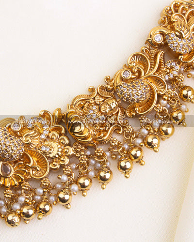 700-W - Necklace Set - Side section of short necklace showing god idol and floral CZ motifs with fringe