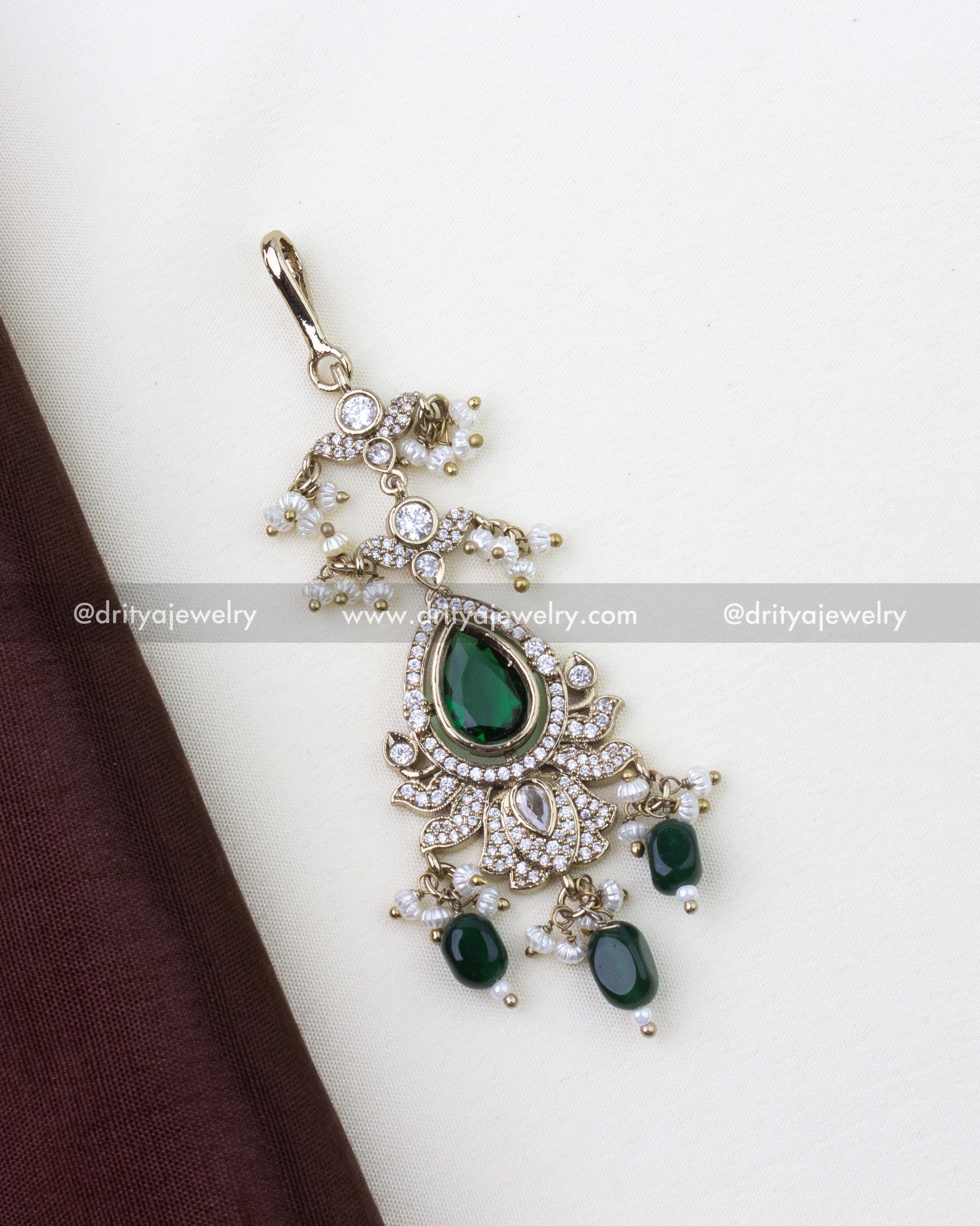 1275-G close-up of emerald and stone-studded maang tikka with bead drops