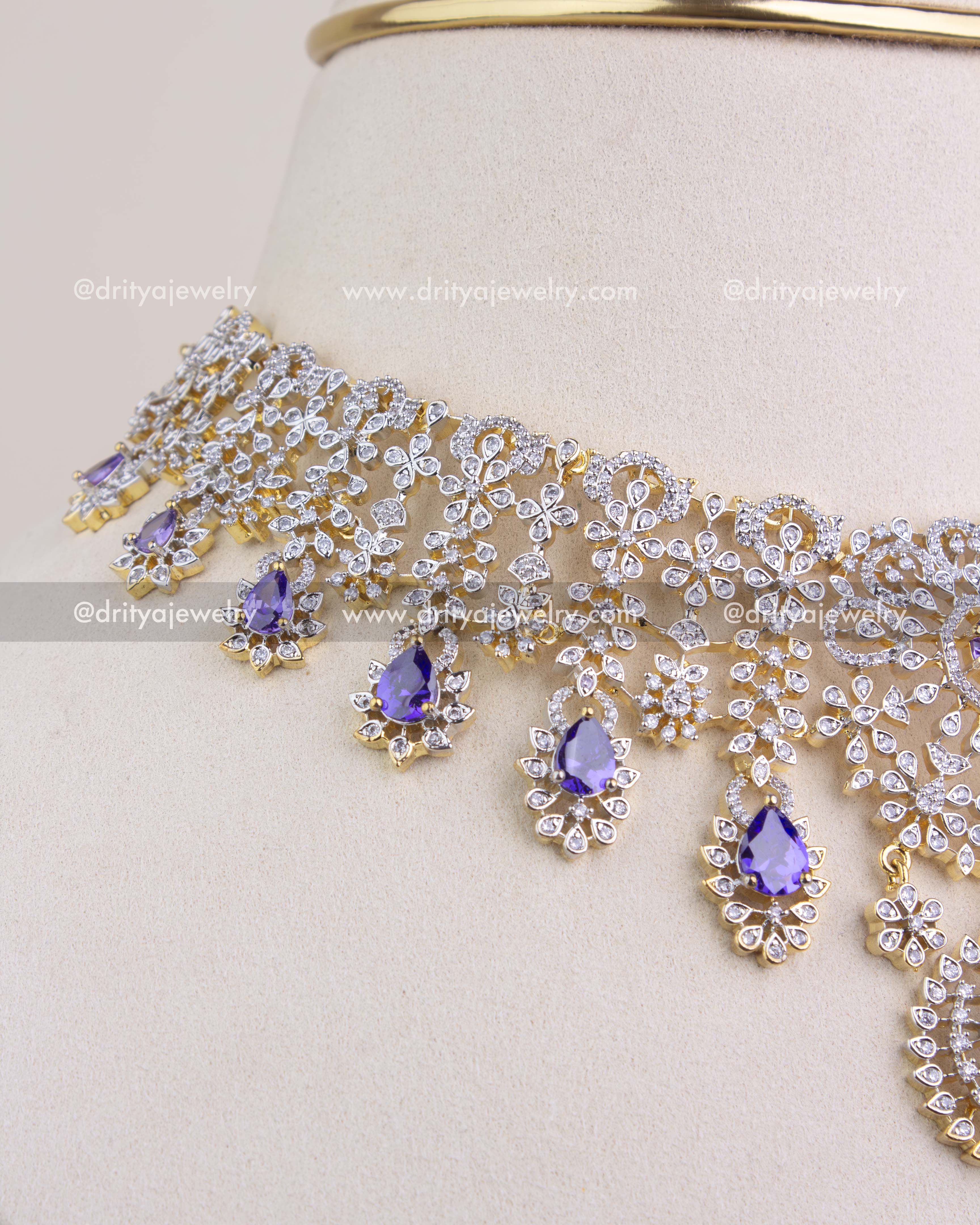 Side angle of CZ studded short necklace highlighting dangling purple stone drops