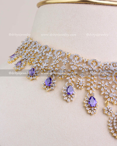 Side angle of CZ studded short necklace highlighting dangling purple stone drops