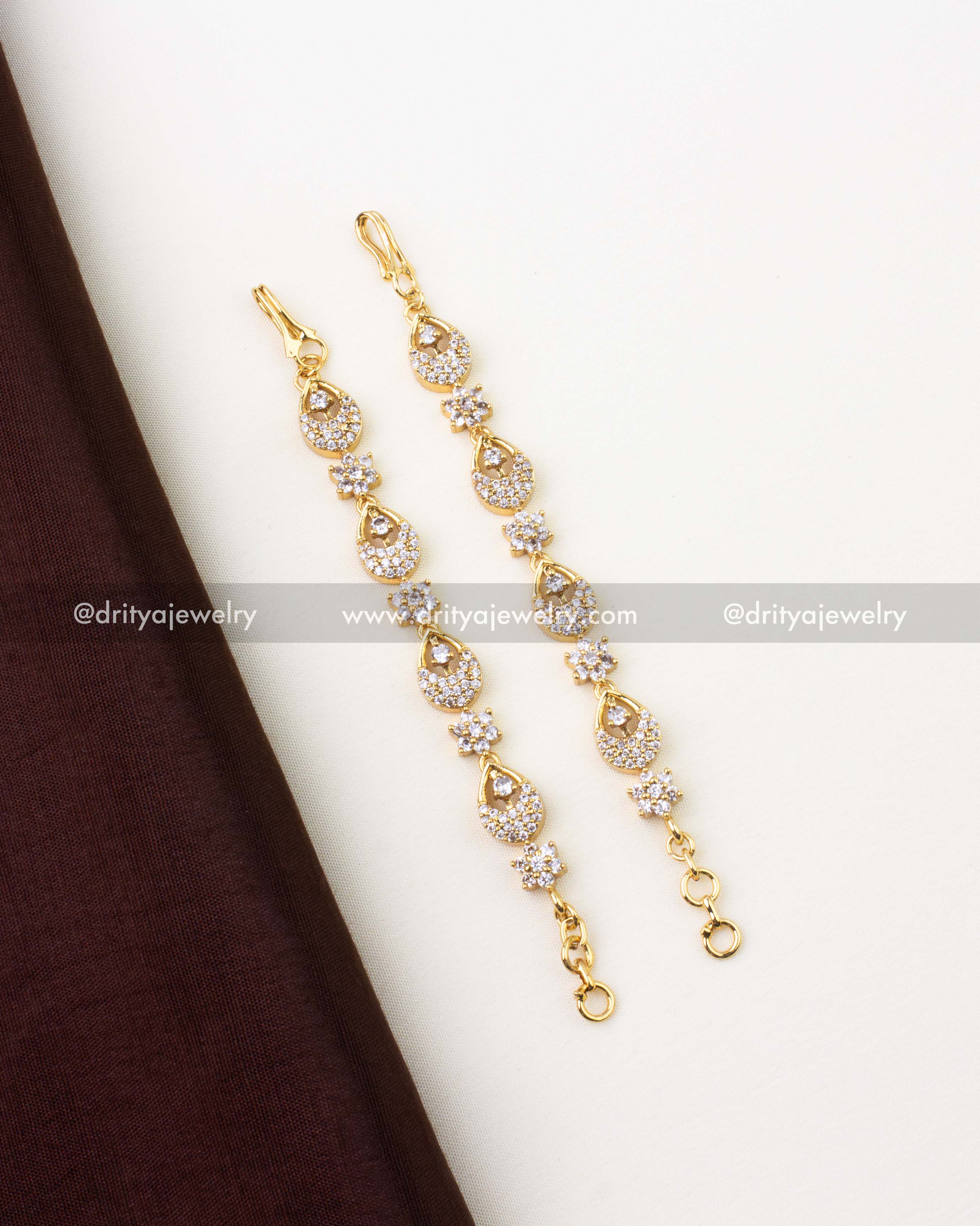 1302-W pair of gold-finish matilu hair chains styled flat on fabric background