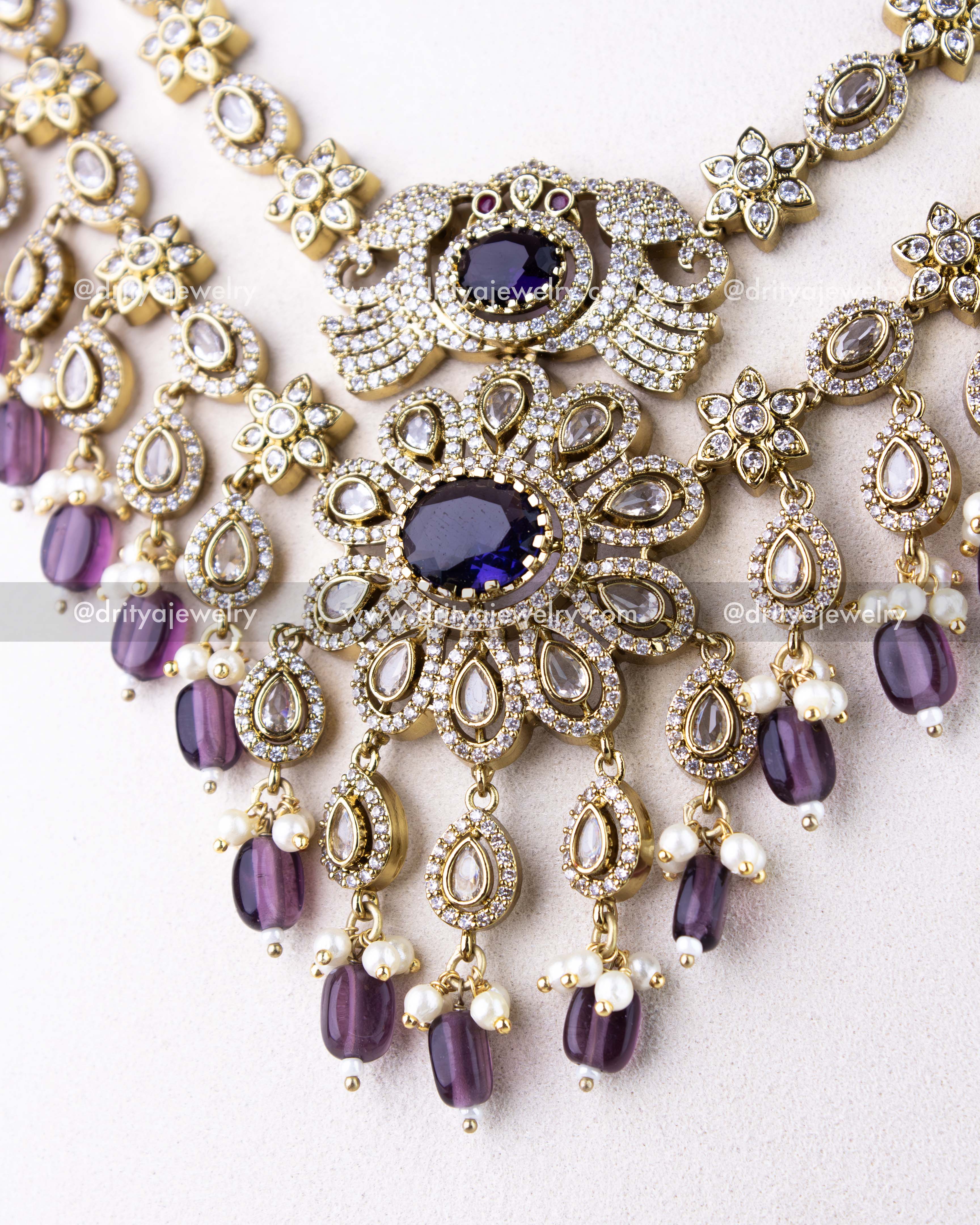 1309-PUSET central pendant detailing with figurine motif and layered purple bead hangings