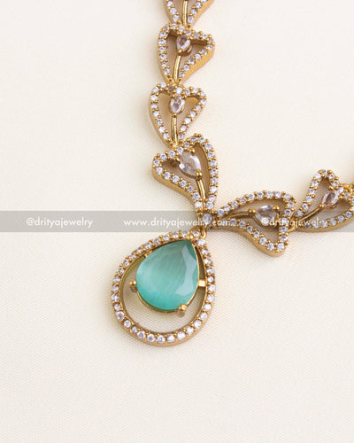 1152-MG Necklace Set - detailed side view of pendant with blush pink pear stone and stone-studded frame