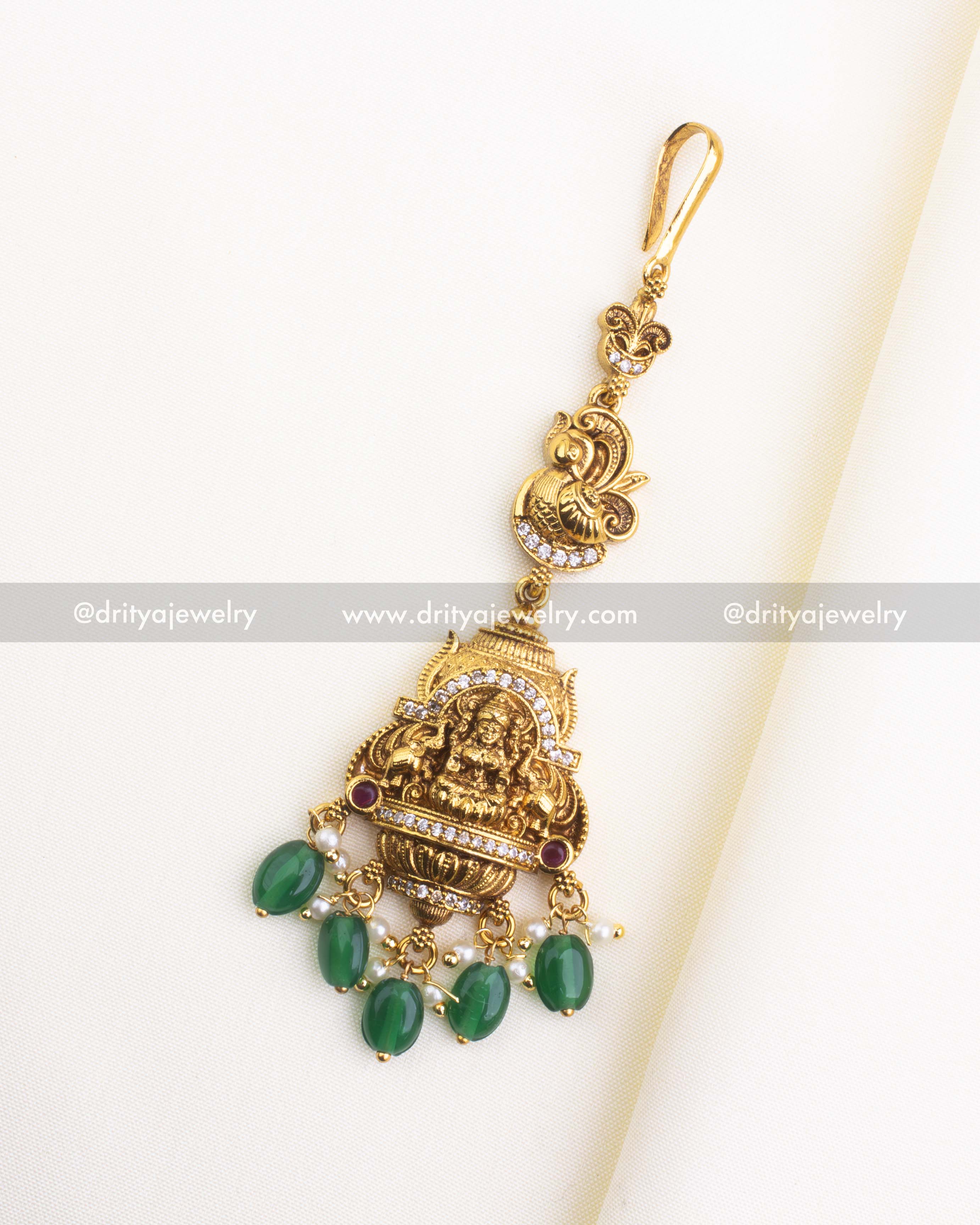 1154-G temple style god idol maang tikka with green bead drops laid flat, front view