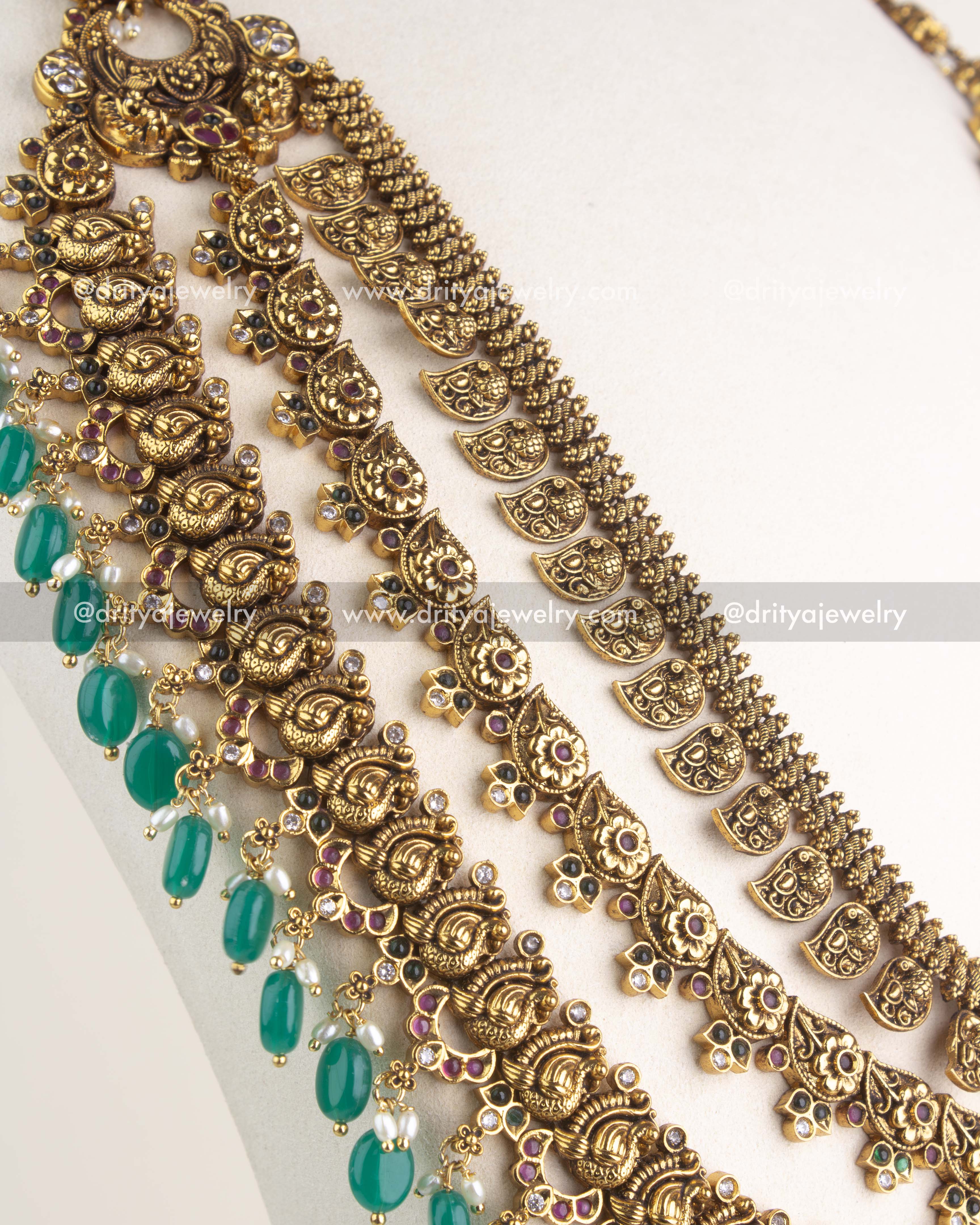 SKU 1164 Necklace Set side angle showing cascading layers and green bead drops along the necklace edge.