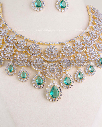 1209-RE close view of emerald teardrop center pendant and halo CZ work