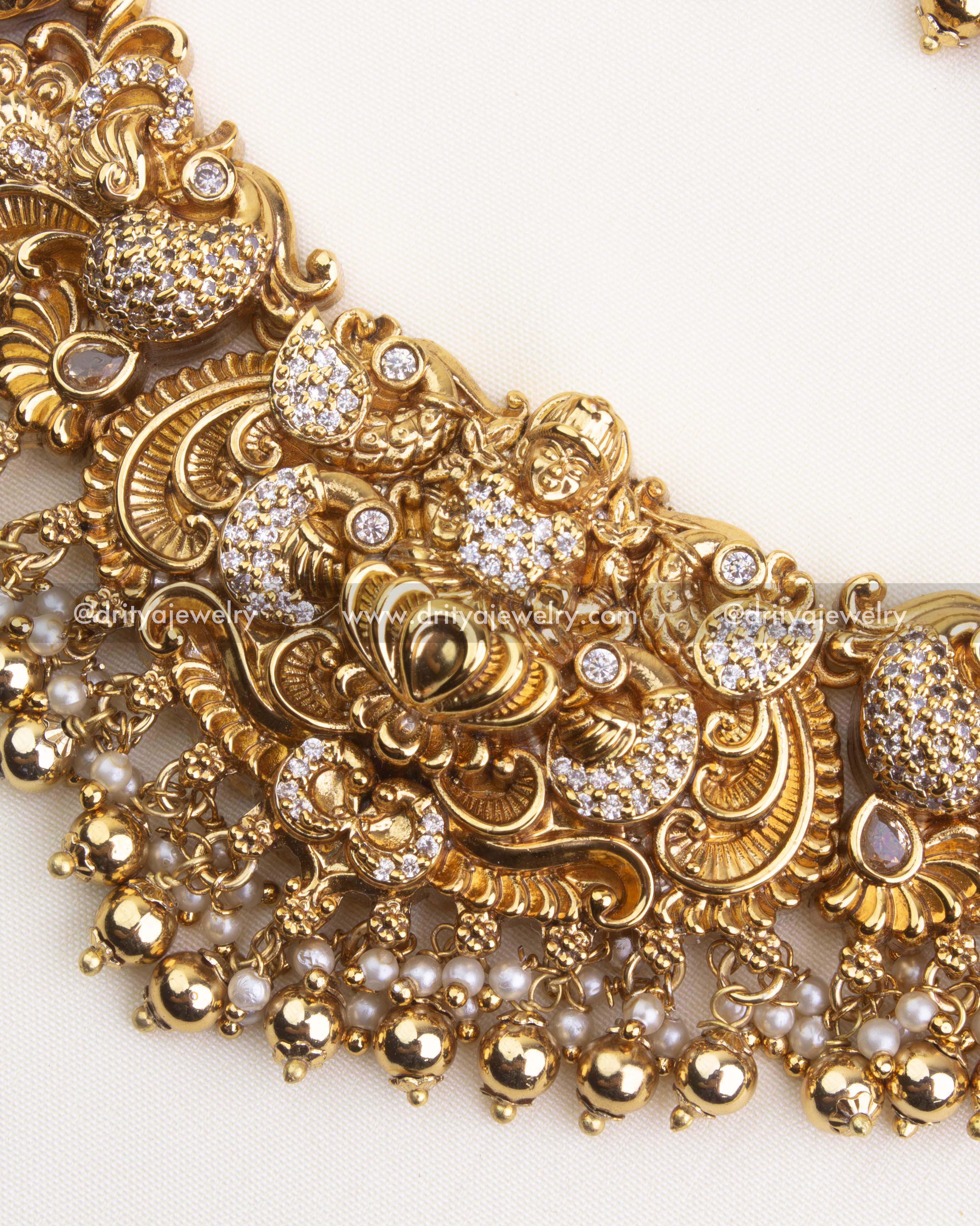 700-W - Necklace Set - Center close-up of god idol pendant with nakshi work and pearl-gold bead drops