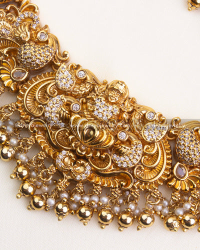 700-W - Necklace Set - Center close-up of god idol pendant with nakshi work and pearl-gold bead drops