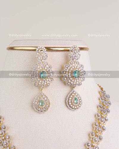 1229-RE matching CZ and emerald-tone dangler earrings close-up