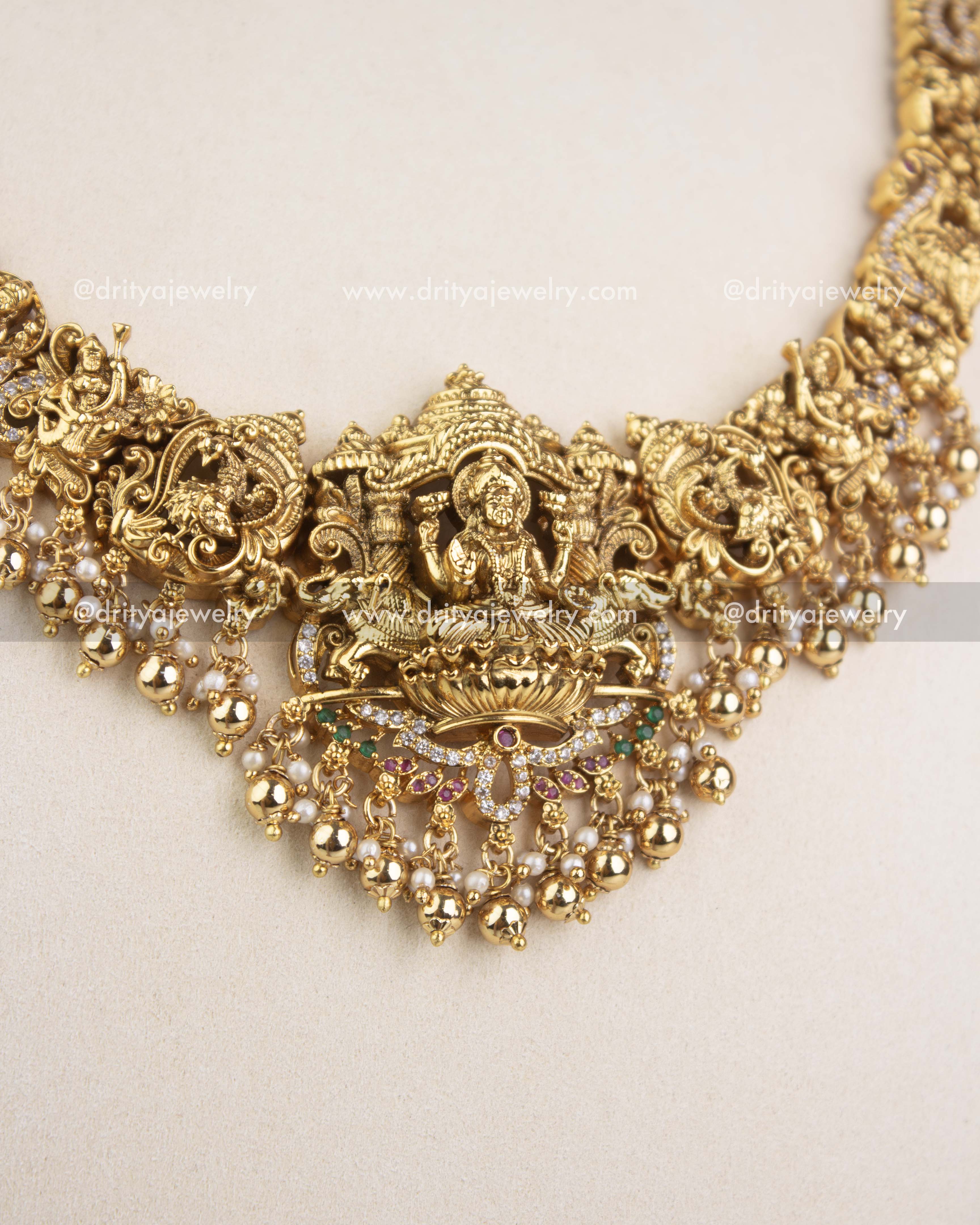 Close-up of temple-style Lakshmi pendant with pearl drops and intricate nakshi work