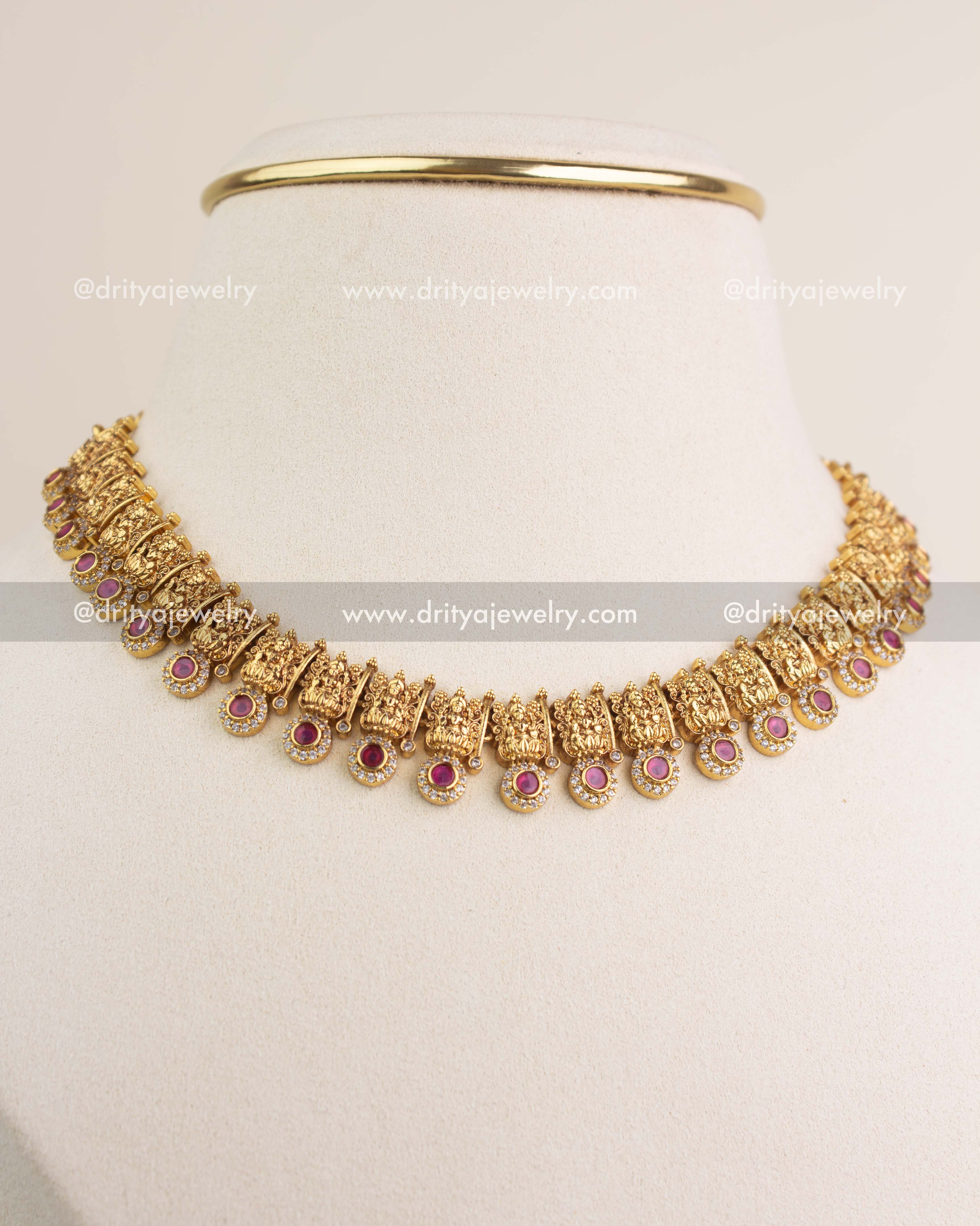 Side-angle view of temple short necklace with red stones