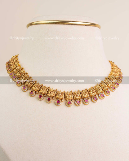 Side-angle view of temple short necklace with red stones